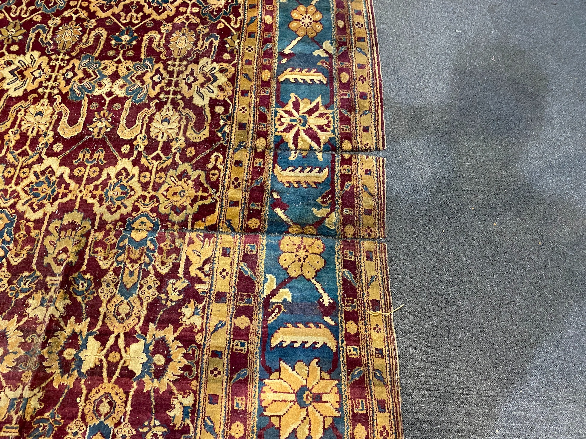 A large Sarouk purple ground carpet, approx. 20ft x 12ft. (cut in one area)